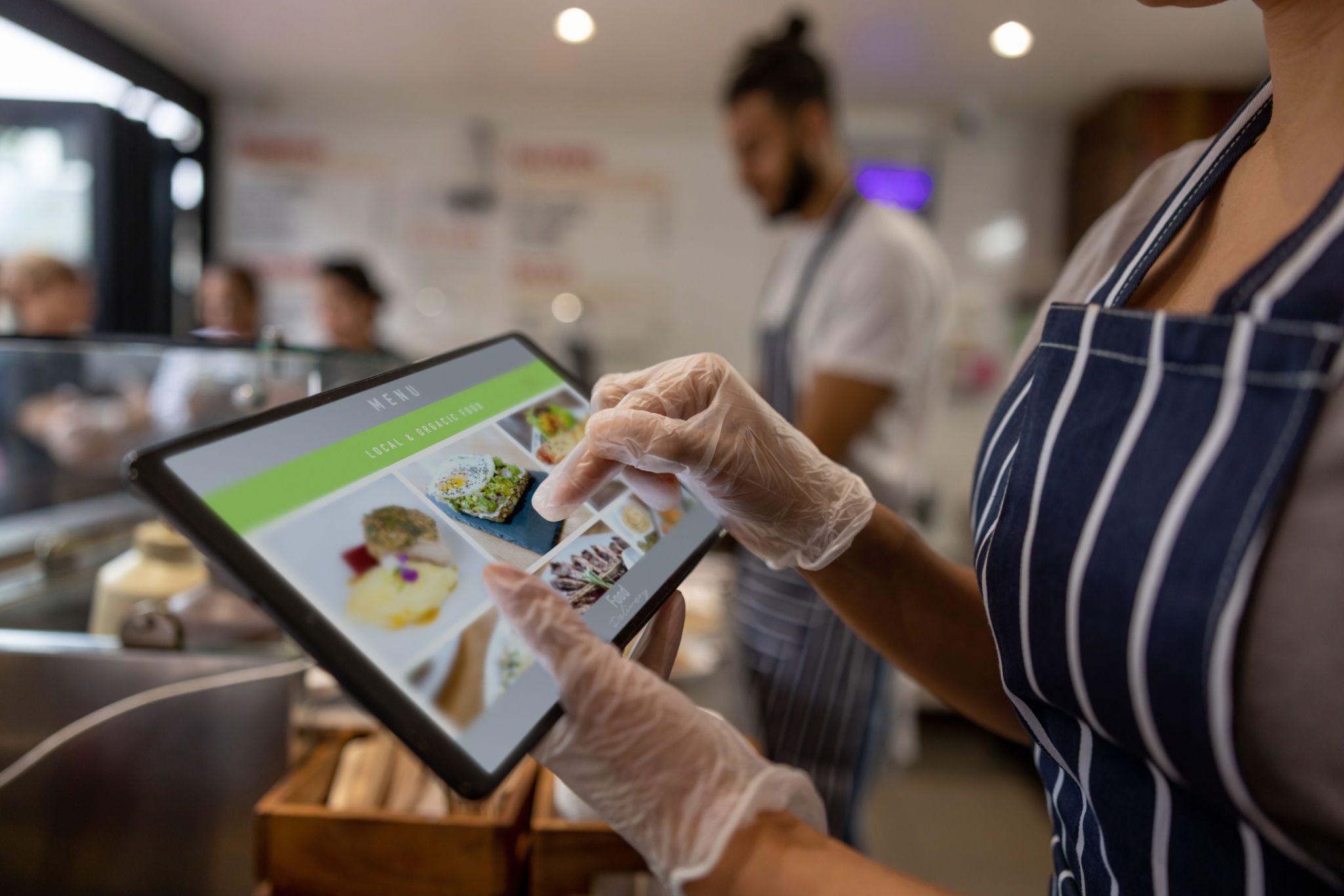 Person ordering food on a tablet