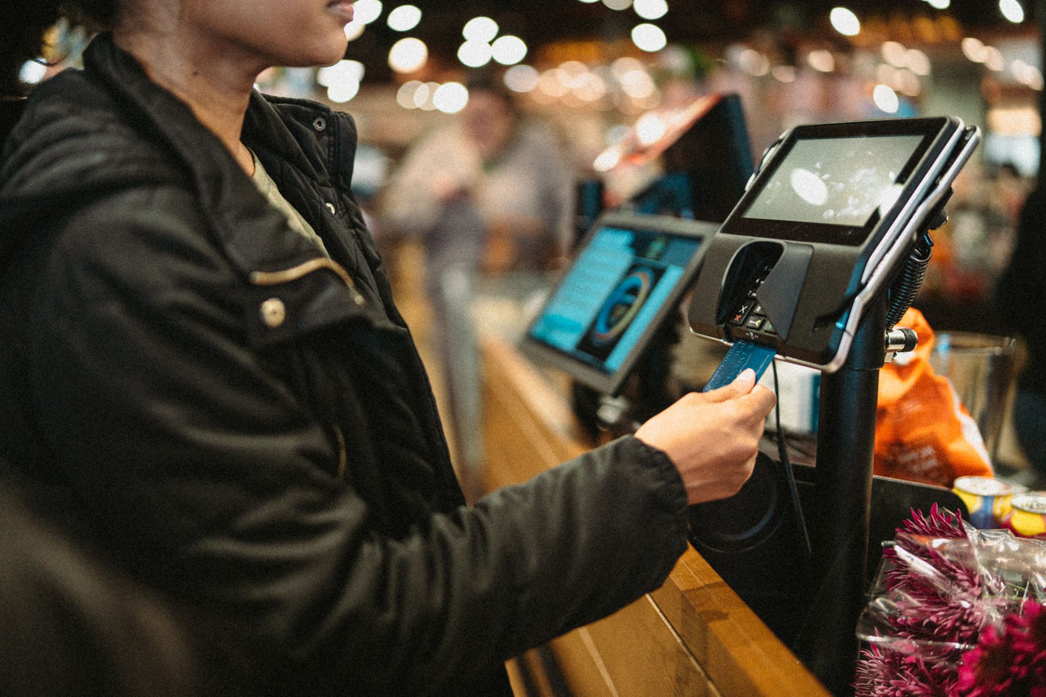 Customer paying at self-checkout kiosk