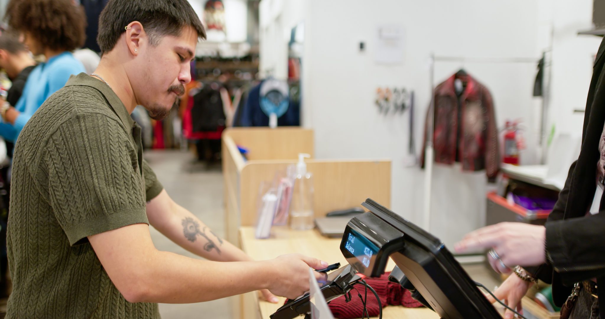 Man paying at clothing store checkout